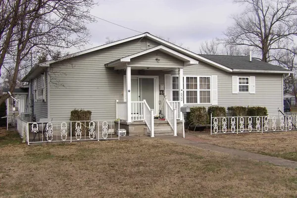 a view of a house with wooden deck and furniture
