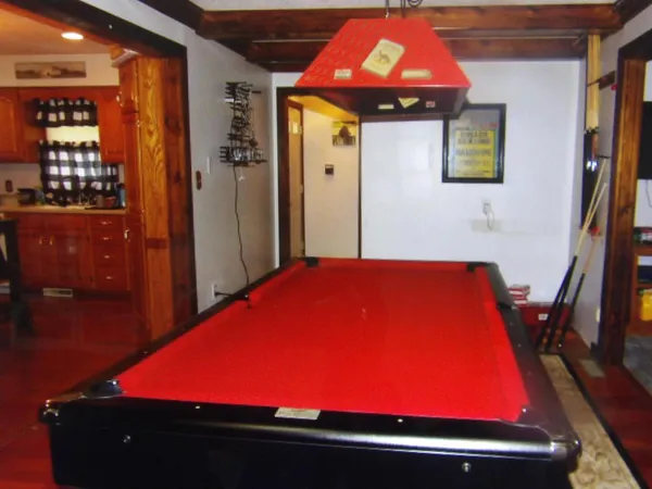 a room with pool table and glass windows
