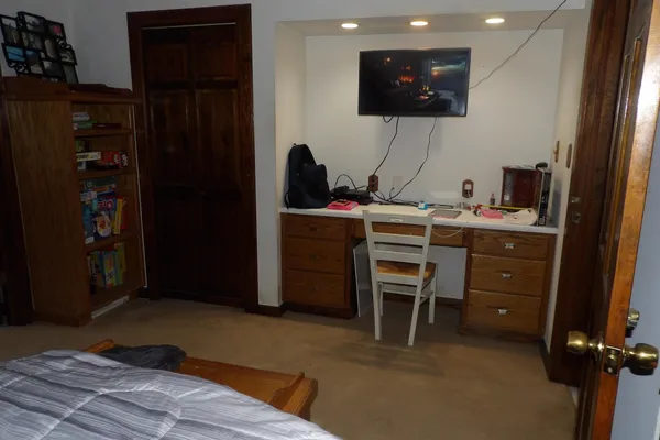 a bedroom with a bed and dresser