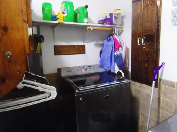 a bathroom with a granite countertop bathtub shower sink vanity and toilet
