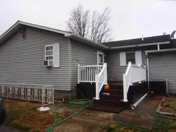 a view of house with a patio