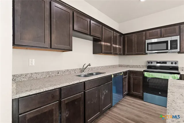 a kitchen with a sink and cabinets