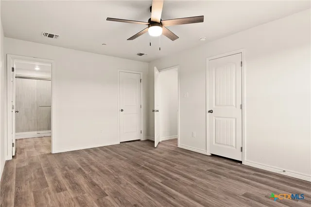 a bathroom with a shower sink vanity and toilet