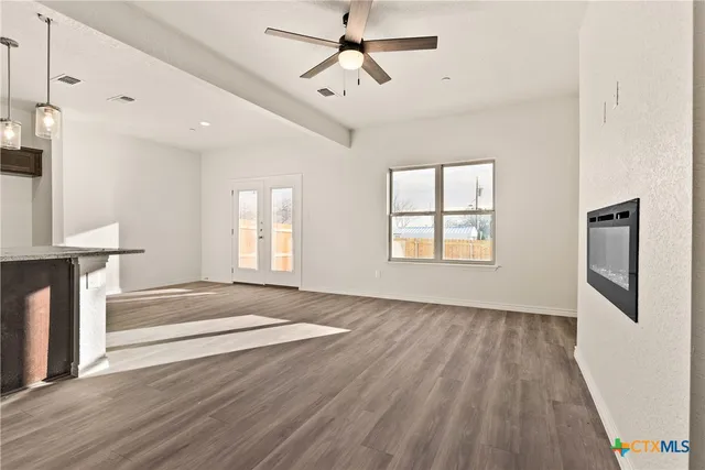 a view of livingroom with hardwood floor and a ceiling fan