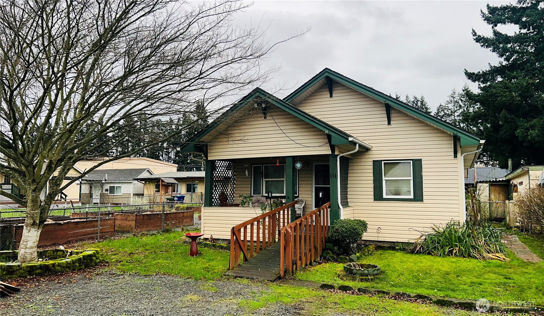 111 Varner Avenue Southeast Orting, WA 98360 - Photo 2 of 17 a front view of a house with a yard garden and outdoor seating