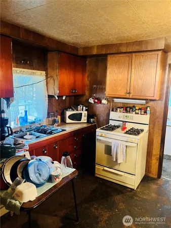 a kitchen with a stove and a refrigerator