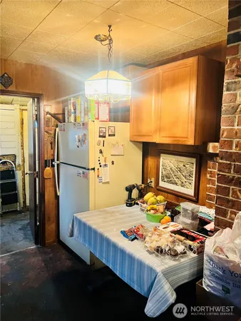 a kitchen with a refrigerator a stove and a sink