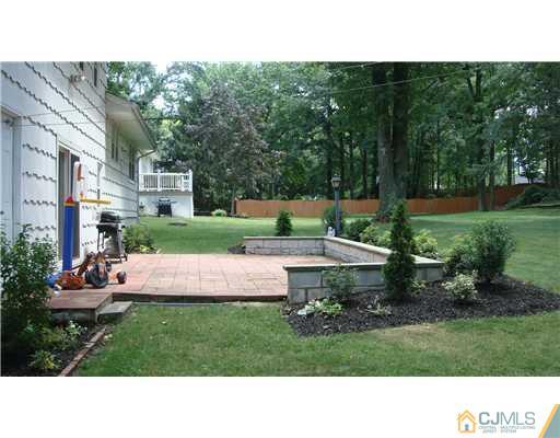 22 Huntington Road Edison, NJ 08820 - Photo 6 of 9 a front view of a house with a yard