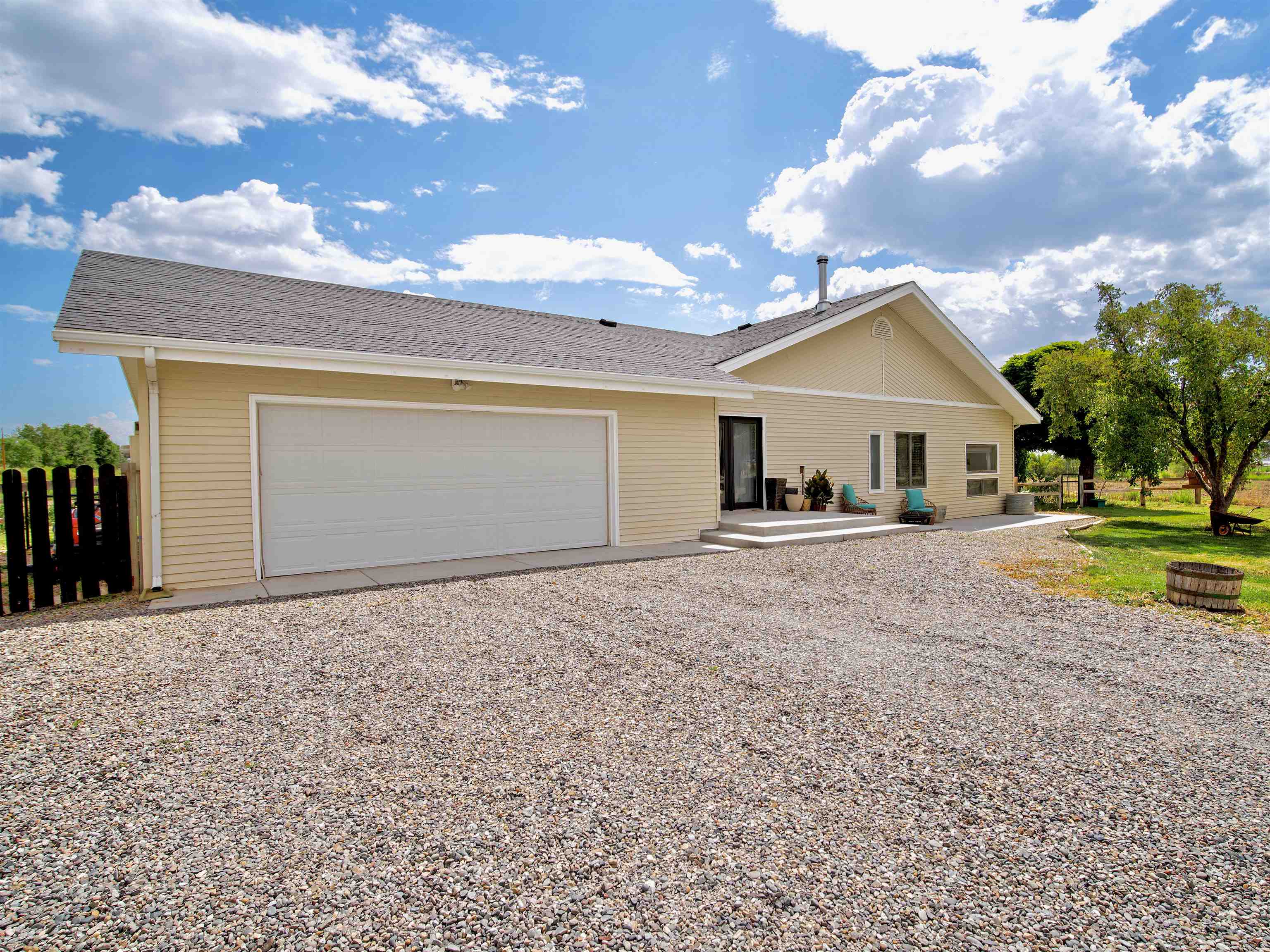 948 20 Road Fruita, CO 81521 - Photo 2 of 38 a view of a house with a yard and garage