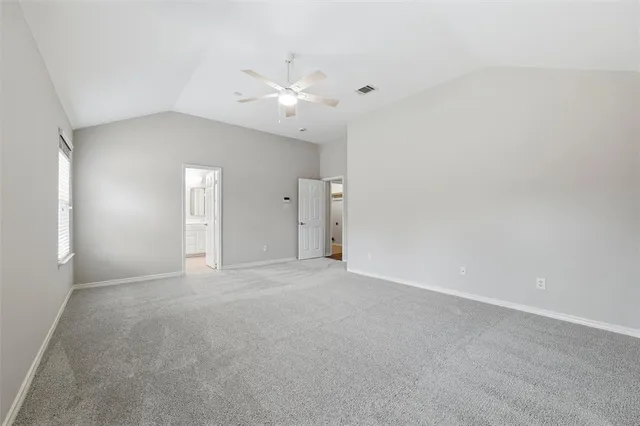 a view of an empty room with a ceiling fan