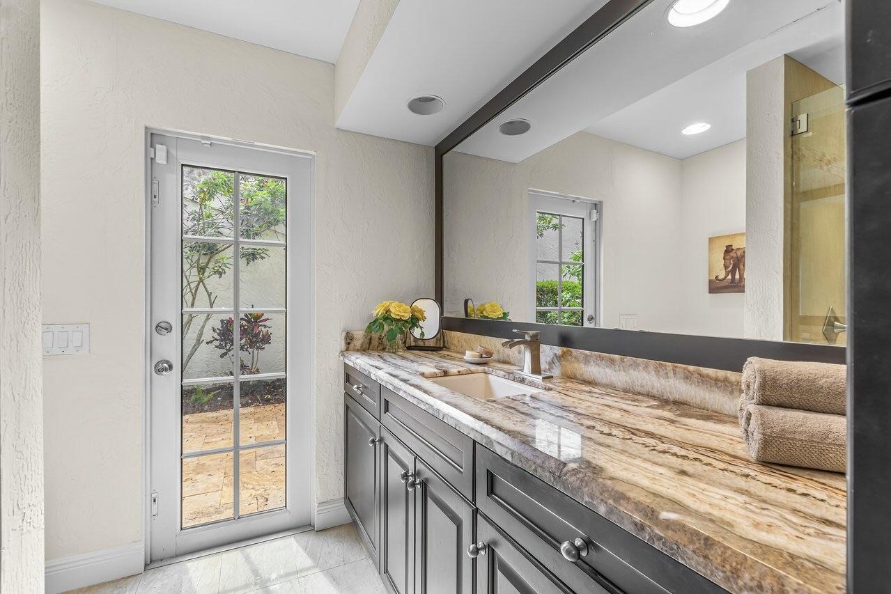 7517 Cedarwood Circle Boca Raton, FL 33434 - Photo 20 of 63 a bathroom with a granite countertop sink and a large mirror