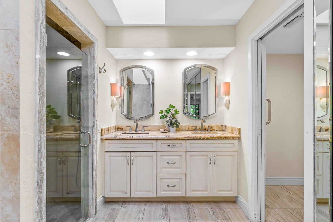 7517 Cedarwood Circle Boca Raton, FL 33434 - Photo 26 of 63 a bathroom with a double vanity sink and mirror
