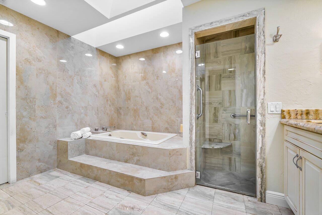 7517 Cedarwood Circle Boca Raton, FL 33434 - Photo 27 of 63 a spacious bathroom with a tub shower and a sink