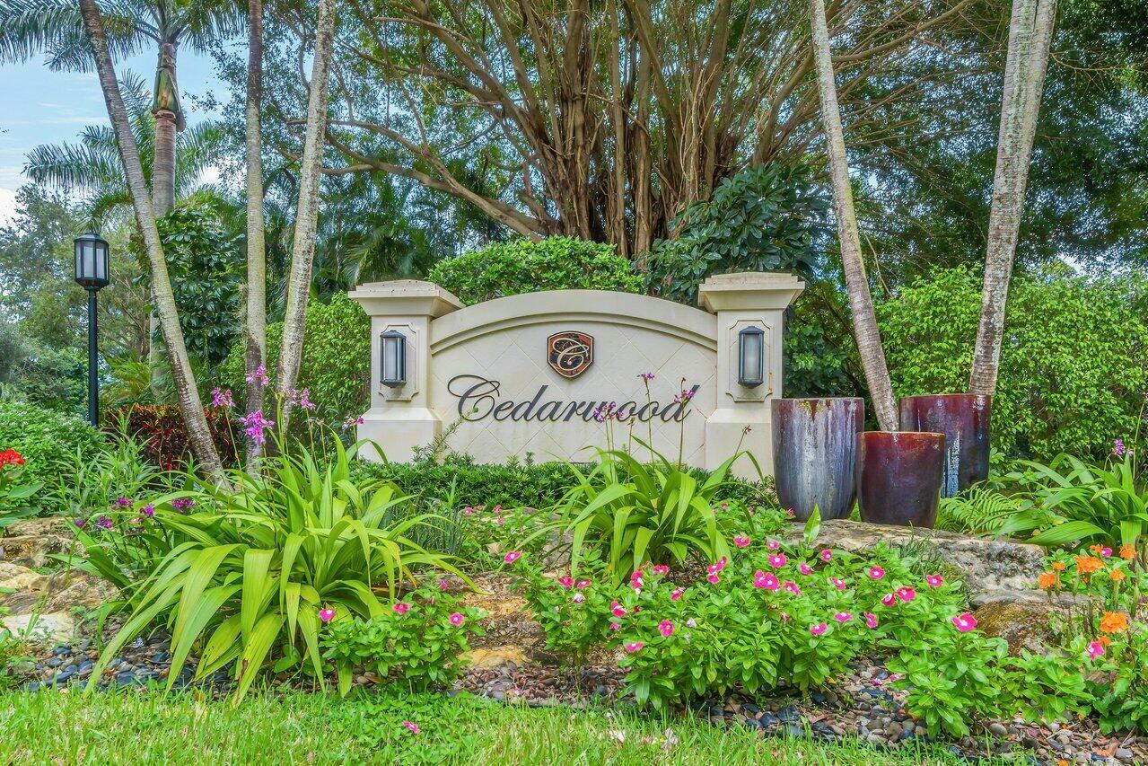 7517 Cedarwood Circle Boca Raton, FL 33434 - Photo 41 of 63 a view of a sign in a yard with potted plants and tree
