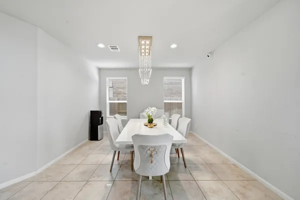 a large kitchen with a large counter top stainless steel appliances and cabinets