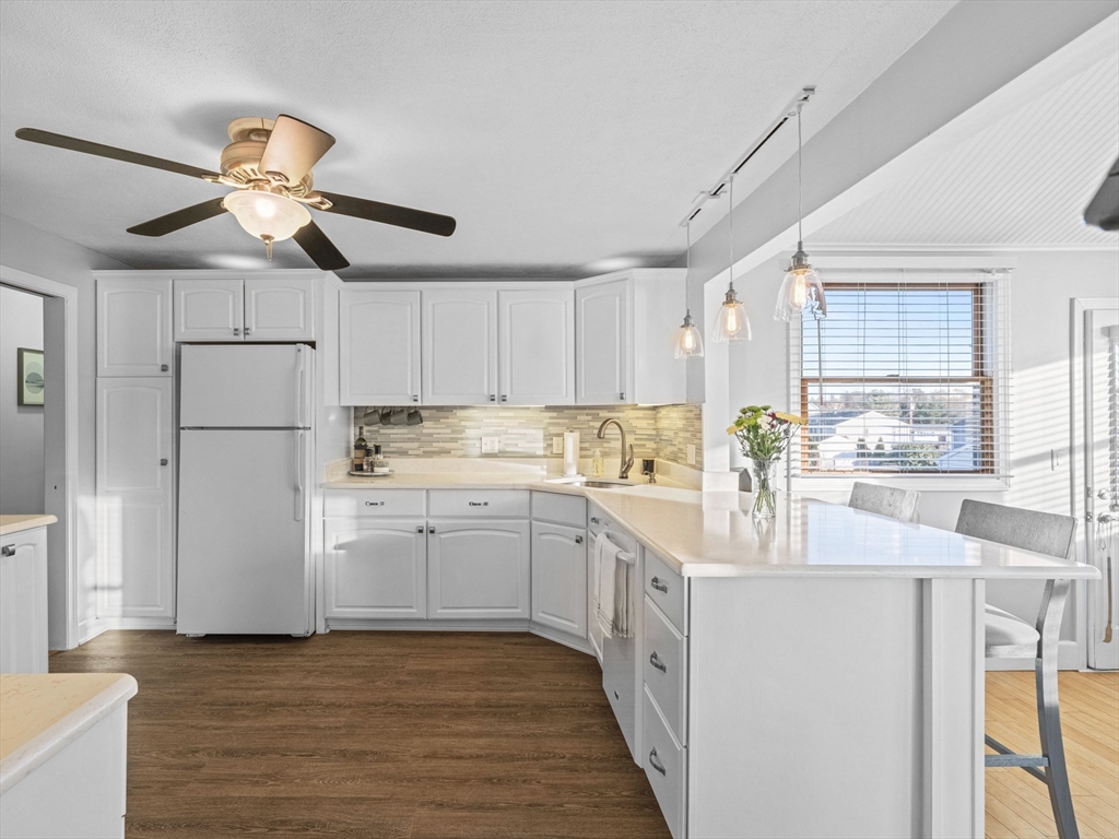 1 Mansfield Drive Wakefield, MA 01880 - Photo 11 of 41 a kitchen with white cabinets and white appliances