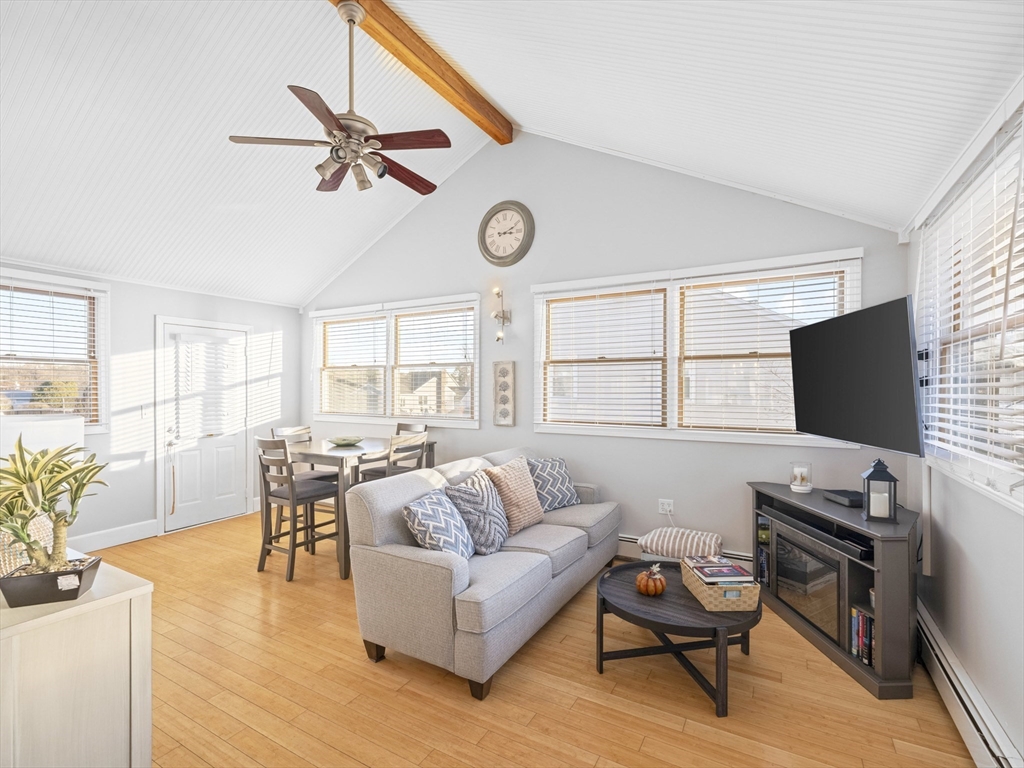 1 Mansfield Drive Wakefield, MA 01880 - Photo 16 of 41 a living room with furniture a fireplace and a flat screen tv