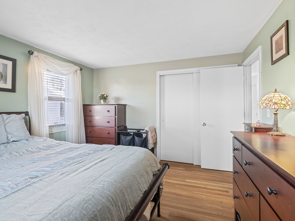 1 Mansfield Drive Wakefield, MA 01880 - Photo 19 of 41 a bedroom with a bed and wooden floor