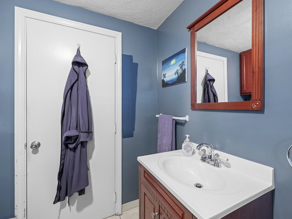 1 Mansfield Drive Wakefield, MA 01880 - Photo 25 of 41 a bathroom with a sink and mirror