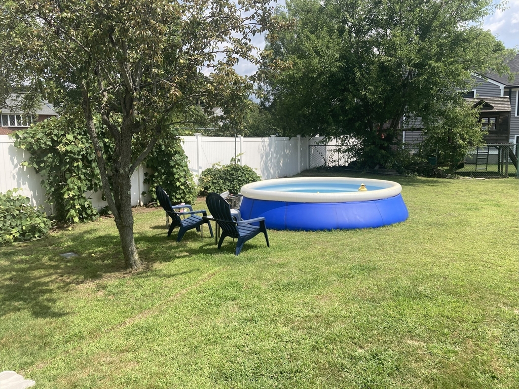 1 Mansfield Drive Wakefield, MA 01880 - Photo 30 of 41 a backyard of a house with table and chairs