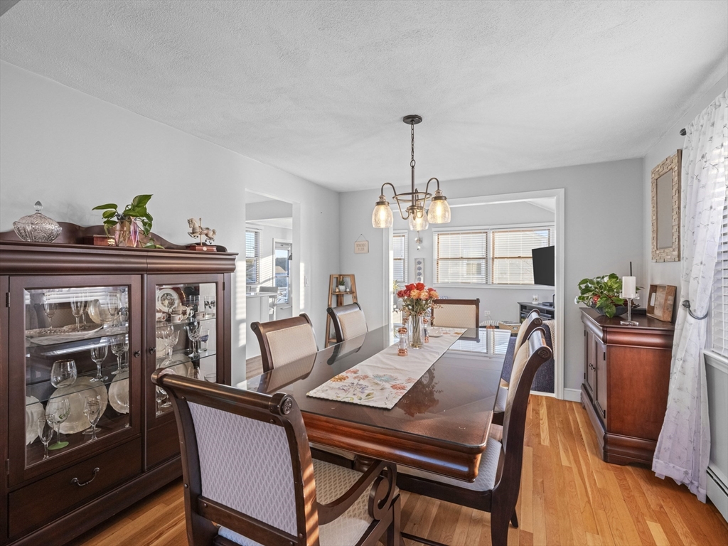 1 Mansfield Drive Wakefield, MA 01880 - Photo 6 of 41 a view of a dining room with furniture a chandelier and wooden floor