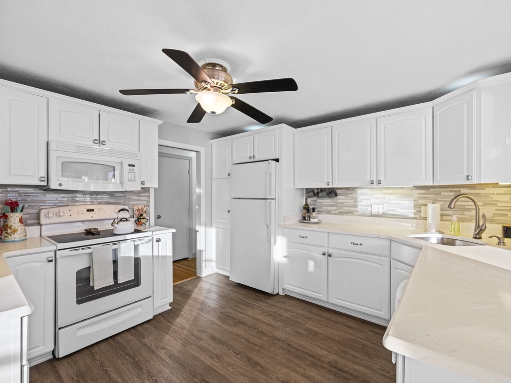 1 Mansfield Drive Wakefield, MA 01880 - Photo 8 of 41 a kitchen with cabinets stainless steel appliances a sink and wooden floor