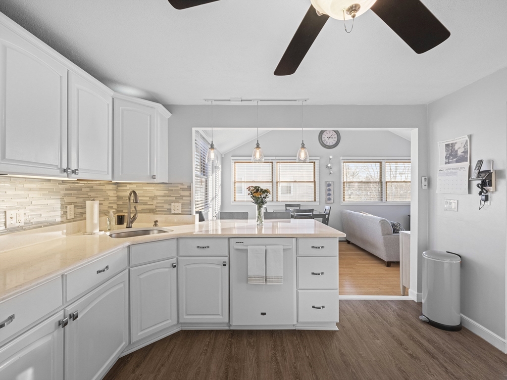 1 Mansfield Drive Wakefield, MA 01880 - Photo 10 of 41 a kitchen with a sink dishwasher and white cabinets with wooden floor