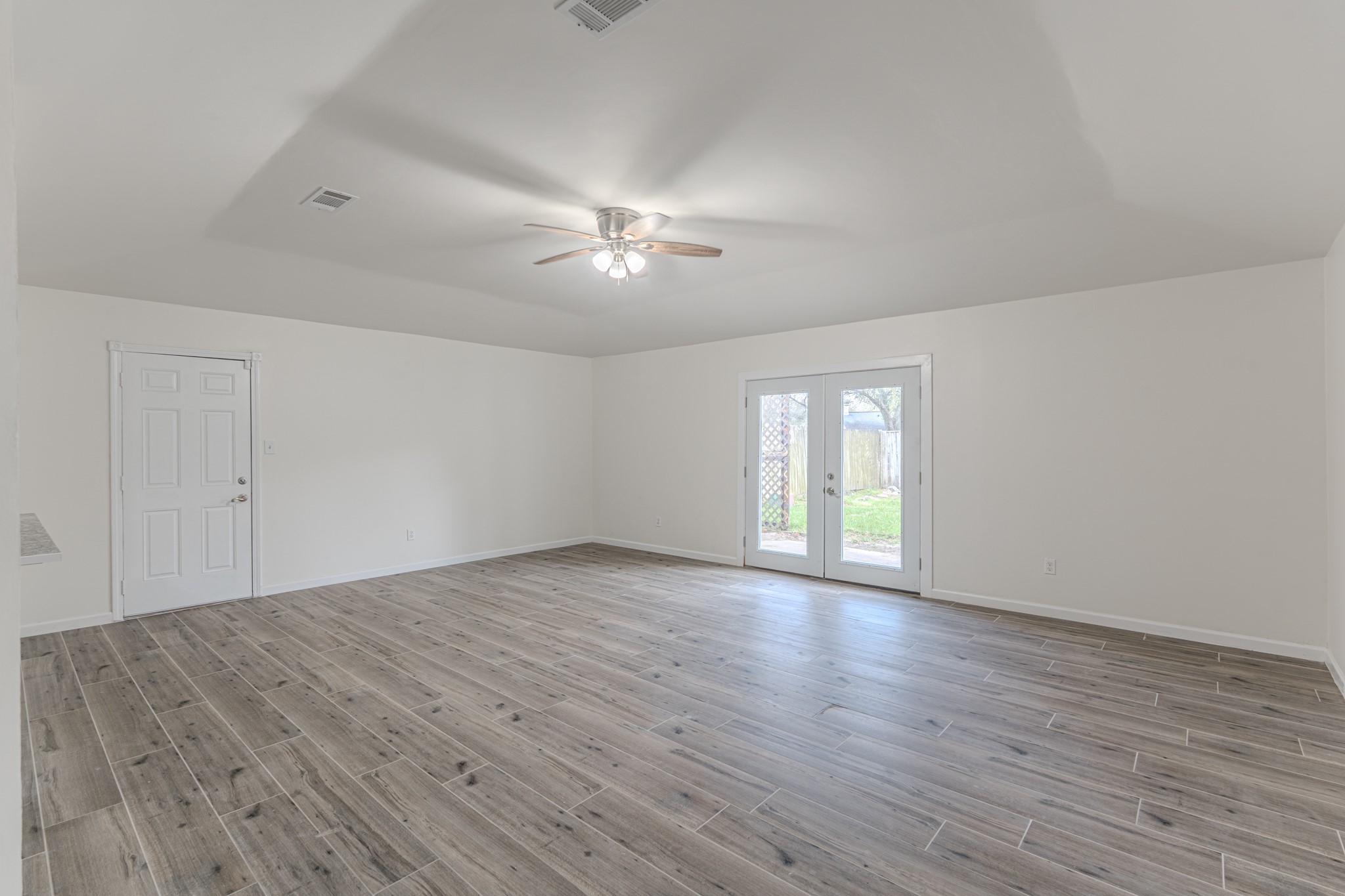 5819 Sunnygate Drive Spring, TX 77373 - Photo 11 of 26 a view of empty room with wooden floor and fan