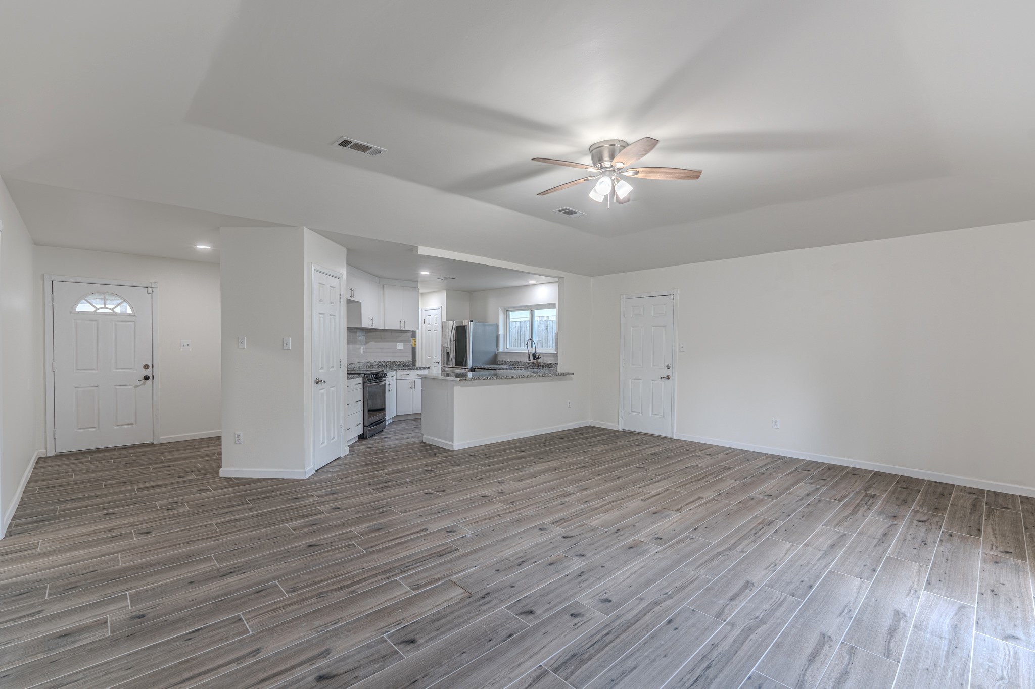5819 Sunnygate Drive Spring, TX 77373 - Photo 12 of 26 a view of empty room with wooden floor and fan