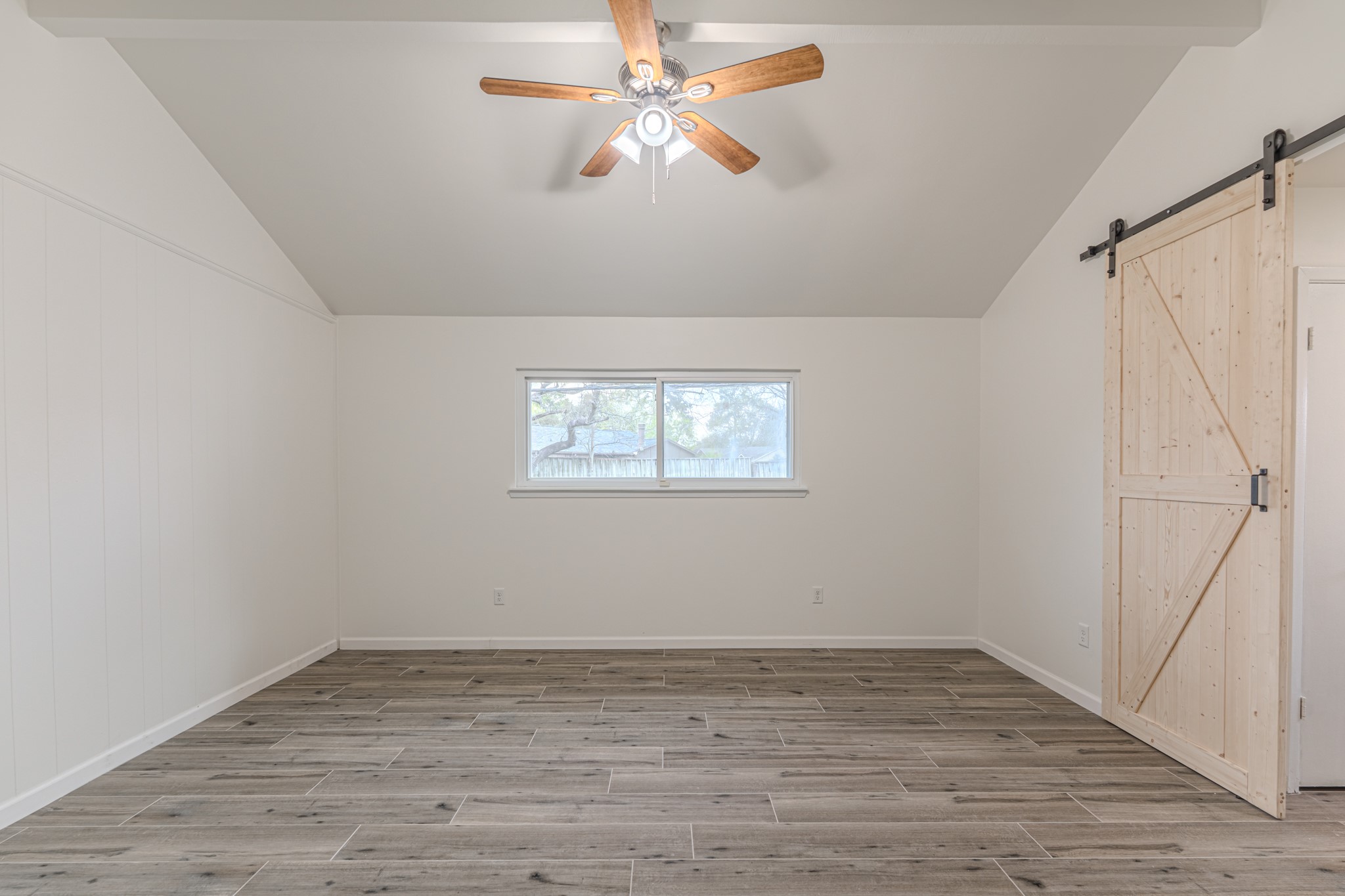 5819 Sunnygate Drive Spring, TX 77373 - Photo 13 of 26 wooden floor in an empty room with a window