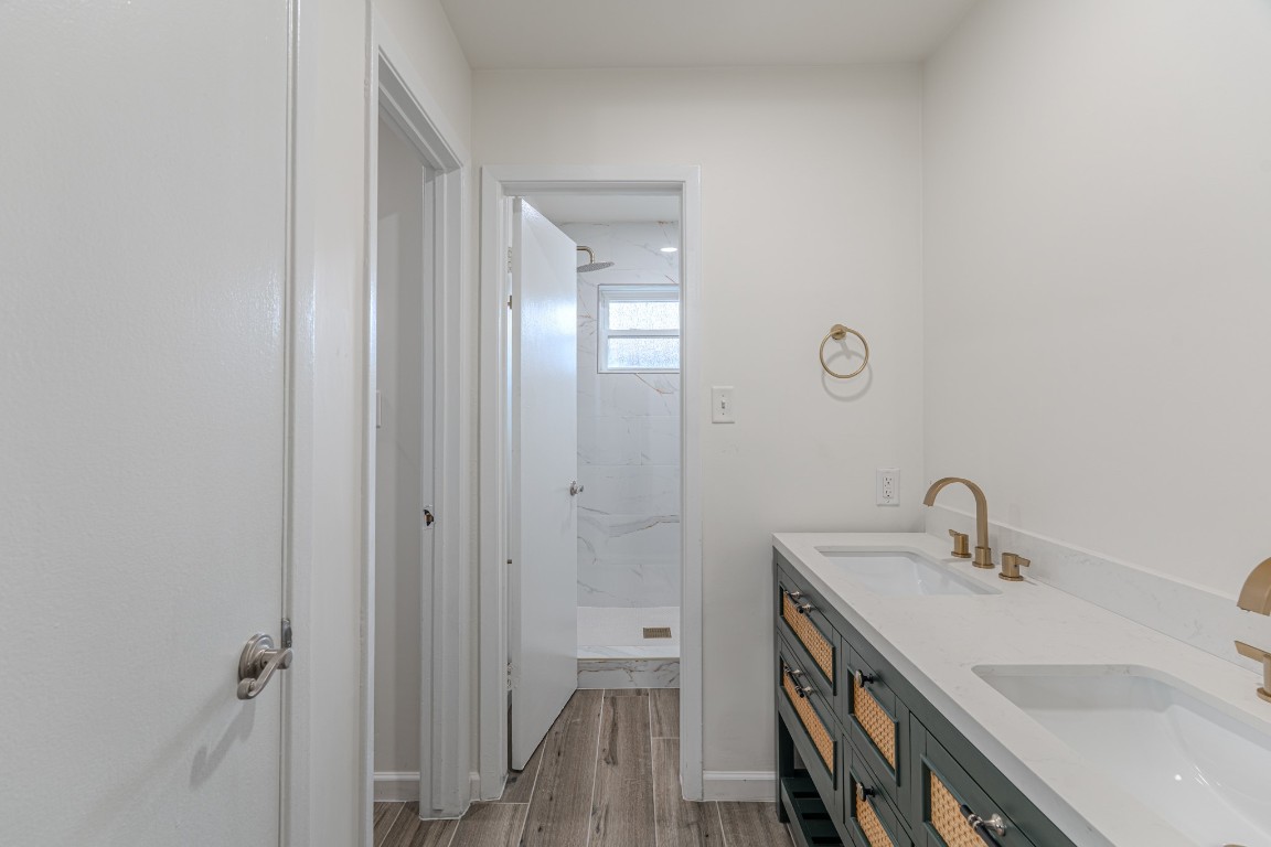5819 Sunnygate Drive Spring, TX 77373 - Photo 15 of 26 a bathroom with a double vanity sink and a mirror