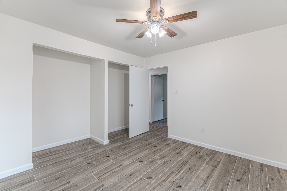 5819 Sunnygate Drive Spring, TX 77373 - Photo 20 of 26 an empty room with wooden floor and windows