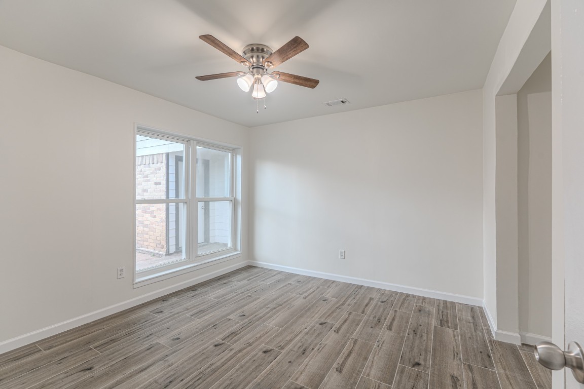 5819 Sunnygate Drive Spring, TX 77373 - Photo 21 of 26 wooden floor in an empty room with a window