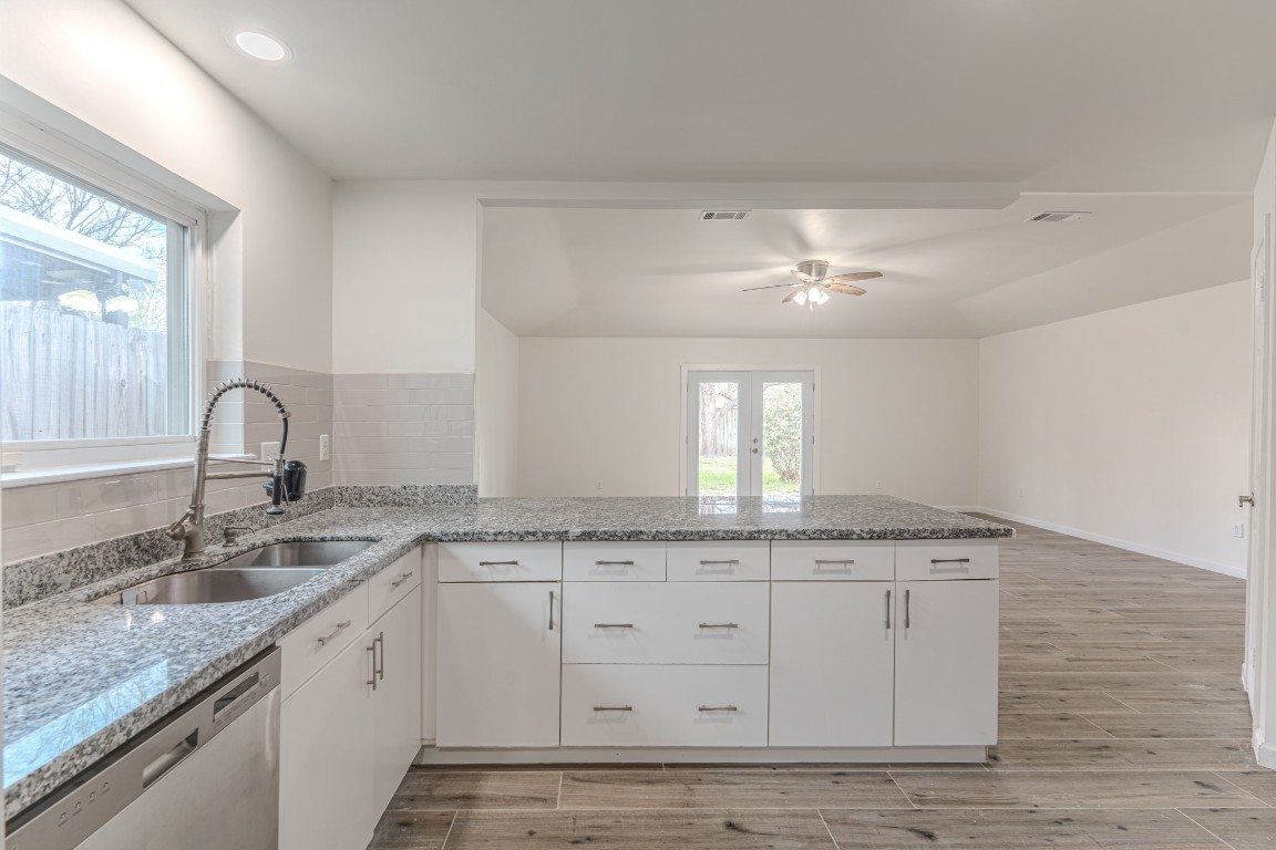 5819 Sunnygate Drive Spring, TX 77373 - Photo 8 of 26 a kitchen with granite countertop a sink and cabinets