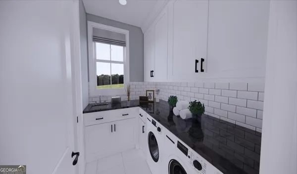 a kitchen with white cabinets and window