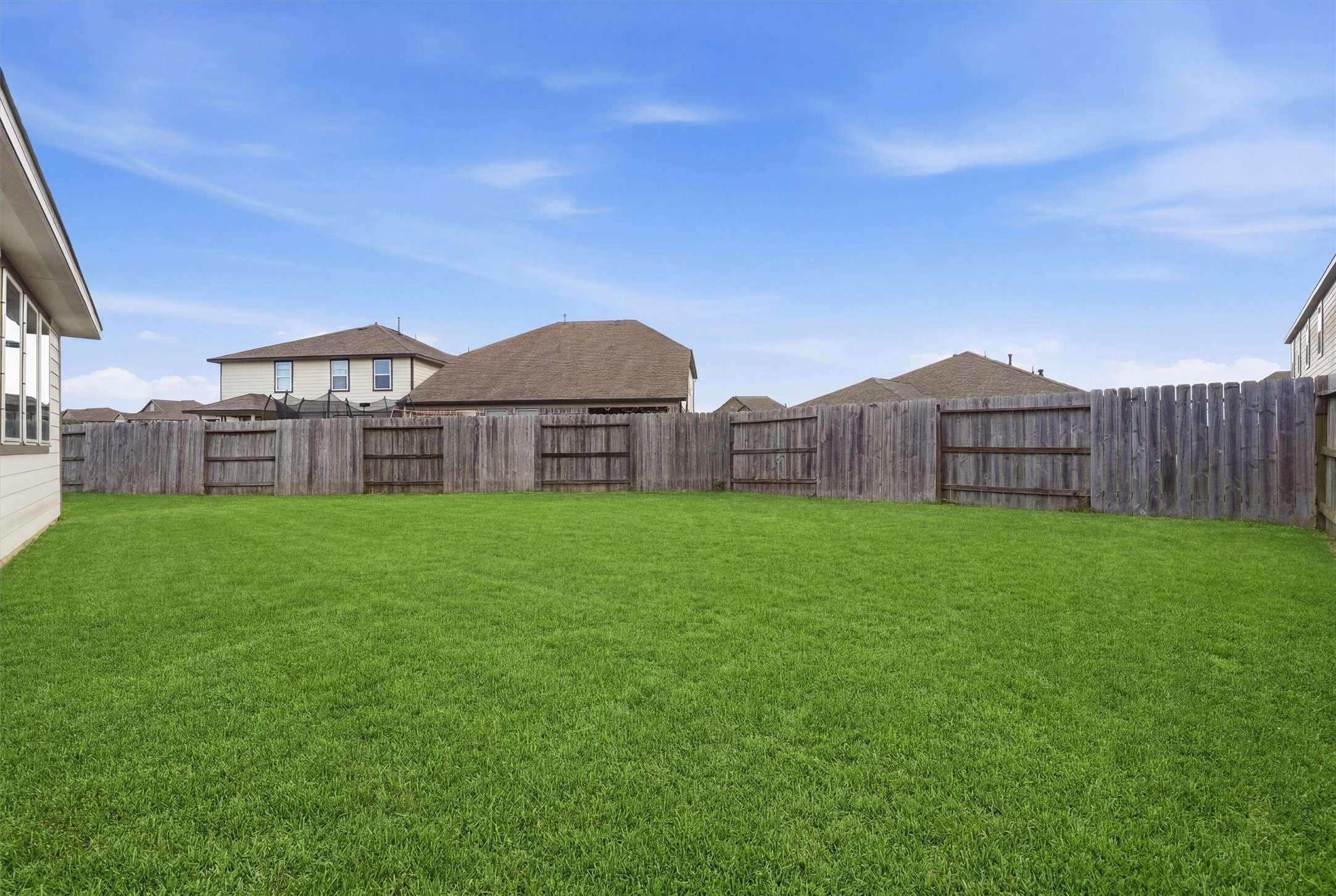 2130 Shellbark Way La Marque, TX 77568 - Photo 22 of 30 Pool sized backyard with a well-maintained lawn, enclosed by a wooden privacy fence, ideal for outdoor activities and gardening.