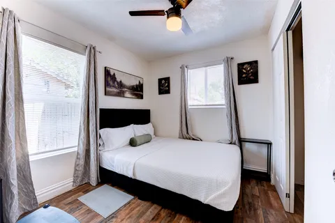 a bedroom with a bed and a window