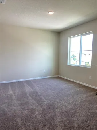 a view of an empty room and closet area