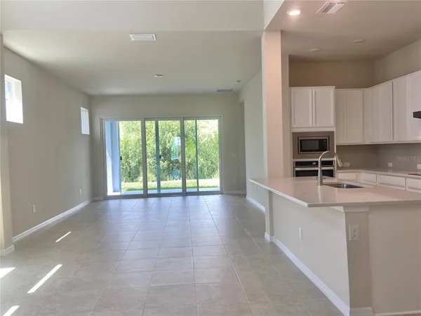 a kitchen with granite countertop a sink and cabinets