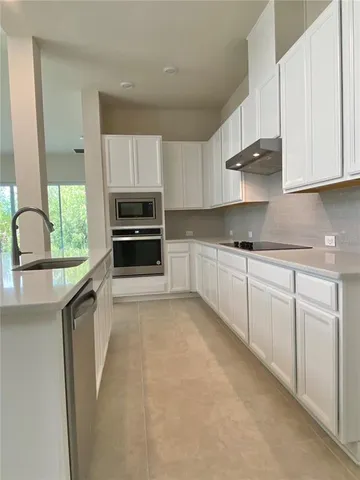 a kitchen with a sink and a toilet