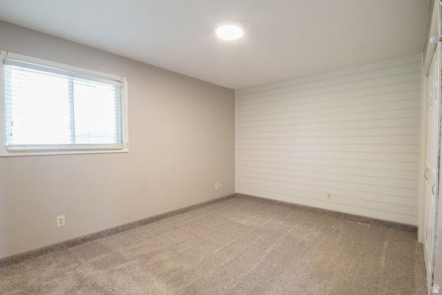 634 South 2100th Street West Vernal, UT 84078 - Photo 28 of 71 Room featuring light gray walls, plush gray carpeting, a single window with blinds, and a white shiplap accent wall
