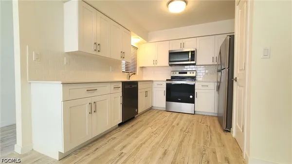 a kitchen with stainless steel appliances granite countertop a stove and a refrigerator