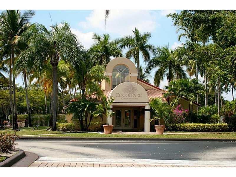 951 Lyons Road, Unit 6206 Coconut Creek, FL 33063 - Photo 16 of 27 a front view of a house with a garden