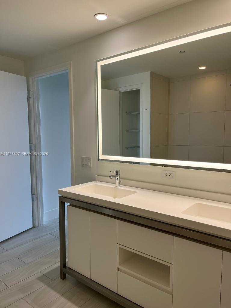 2000 Metropica Way, Unit 1602 Sunrise, FL 33323 - Photo 20 of 50 a bathroom with a sink and a mirror