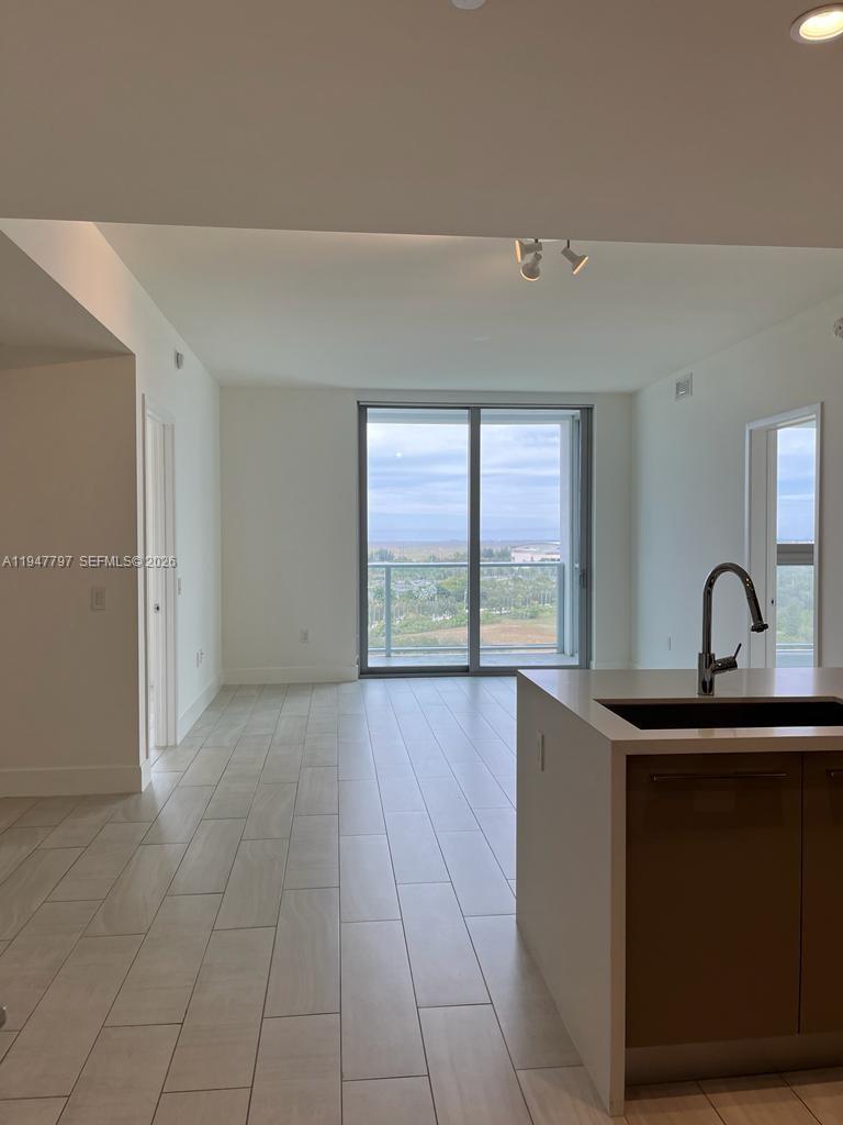 2000 Metropica Way, Unit 1602 Sunrise, FL 33323 - Photo 2 of 50 a kitchen with a sink and large windows