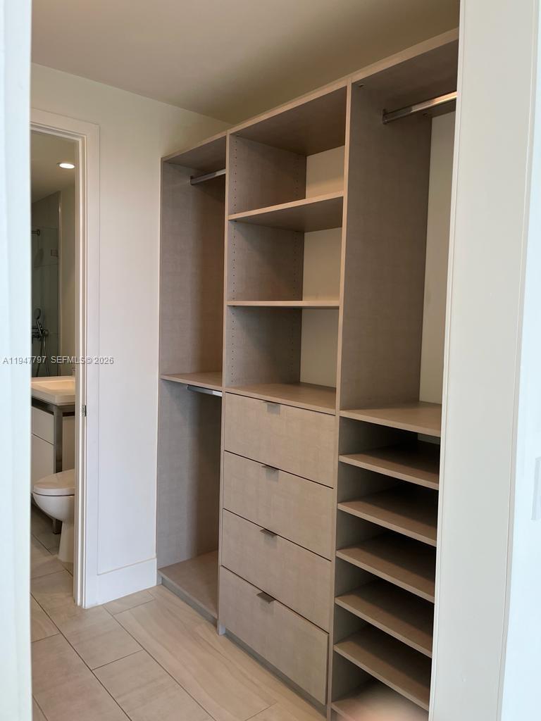 2000 Metropica Way, Unit 1602 Sunrise, FL 33323 - Photo 39 of 50 a view of walk in closet with empty racks