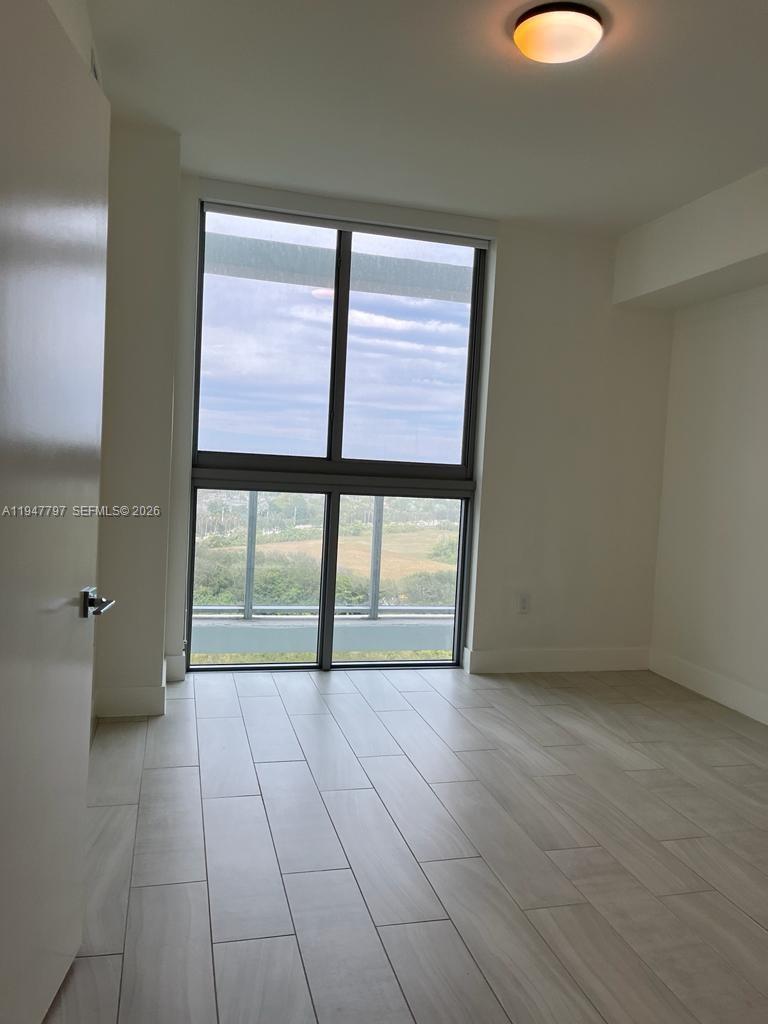2000 Metropica Way, Unit 1602 Sunrise, FL 33323 - Photo 40 of 50 wooden floor in an empty room with a window
