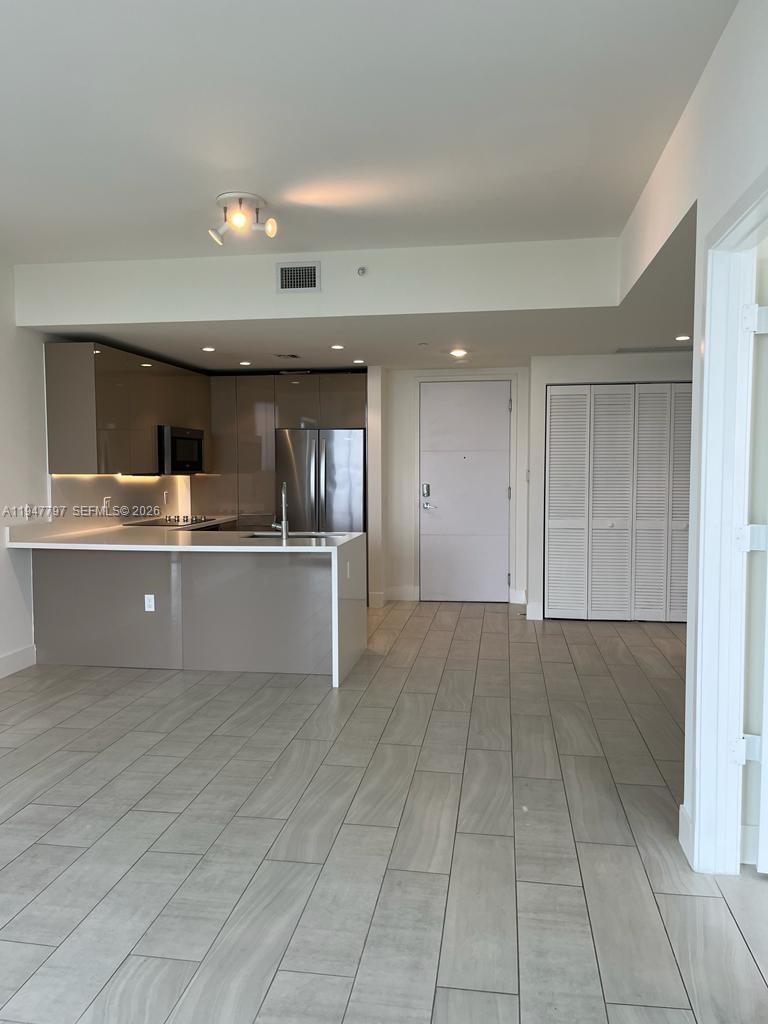 2000 Metropica Way, Unit 1602 Sunrise, FL 33323 - Photo 6 of 50 a view of kitchen with cabinets and refrigerator