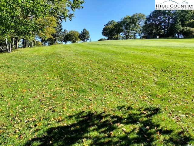 208 Pine Ridge Road Beech Mountain, NC 28604 - Photo 2 of 5 a view of a grassy field with trees