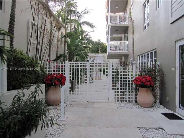 3540 Main Highway, Unit 301 Miami, FL 33133 - Photo 21 of 29 a view of a patio with table and chairs potted plants